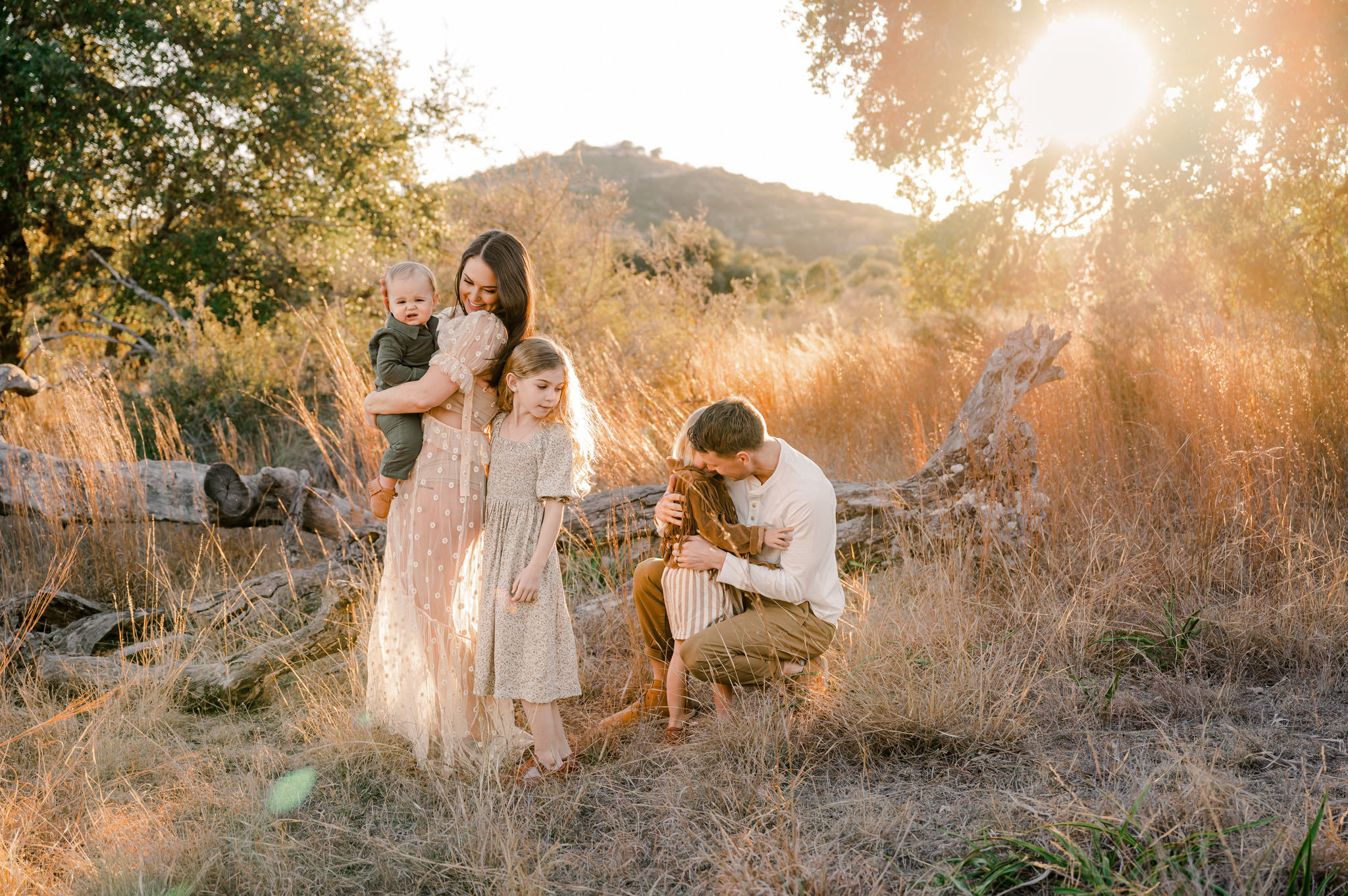 A family of five plays in the glowing light of golden hour at Joshua Springs Park and Preserve. Image by Cassey Golden Photography.